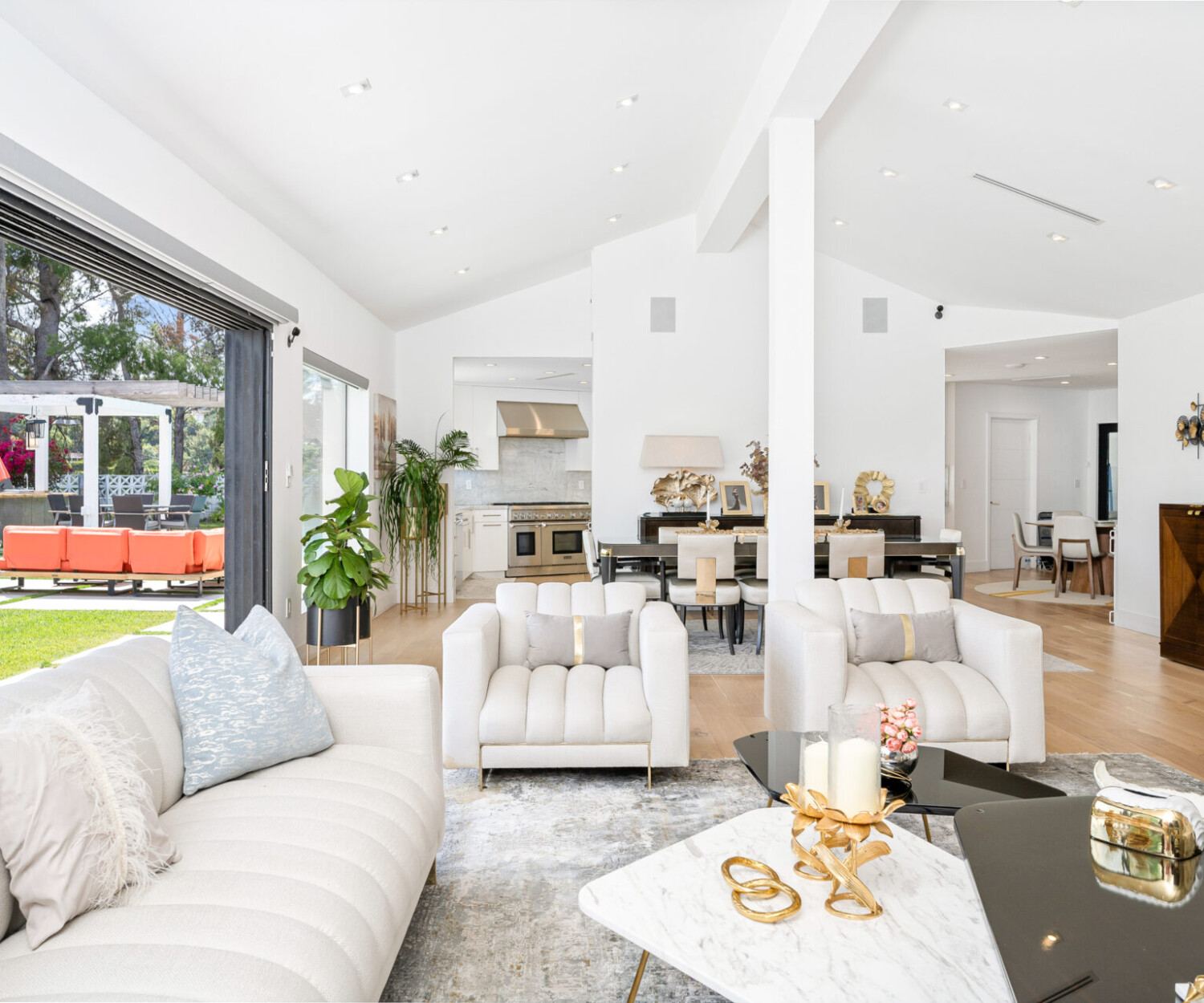 Some white couches and expansive windows offering scenic views in a stylish living room