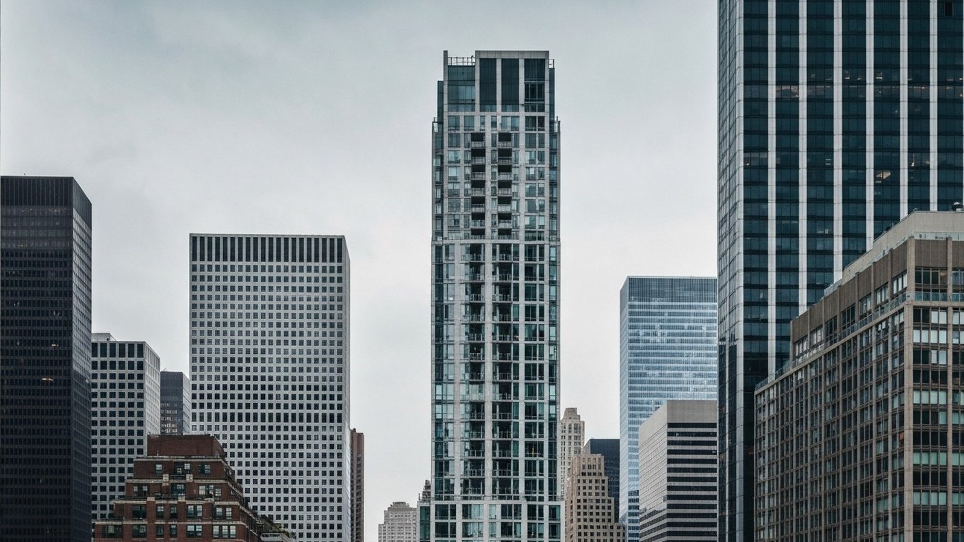sleek modern residential skyscraper among midtown office towers, New York