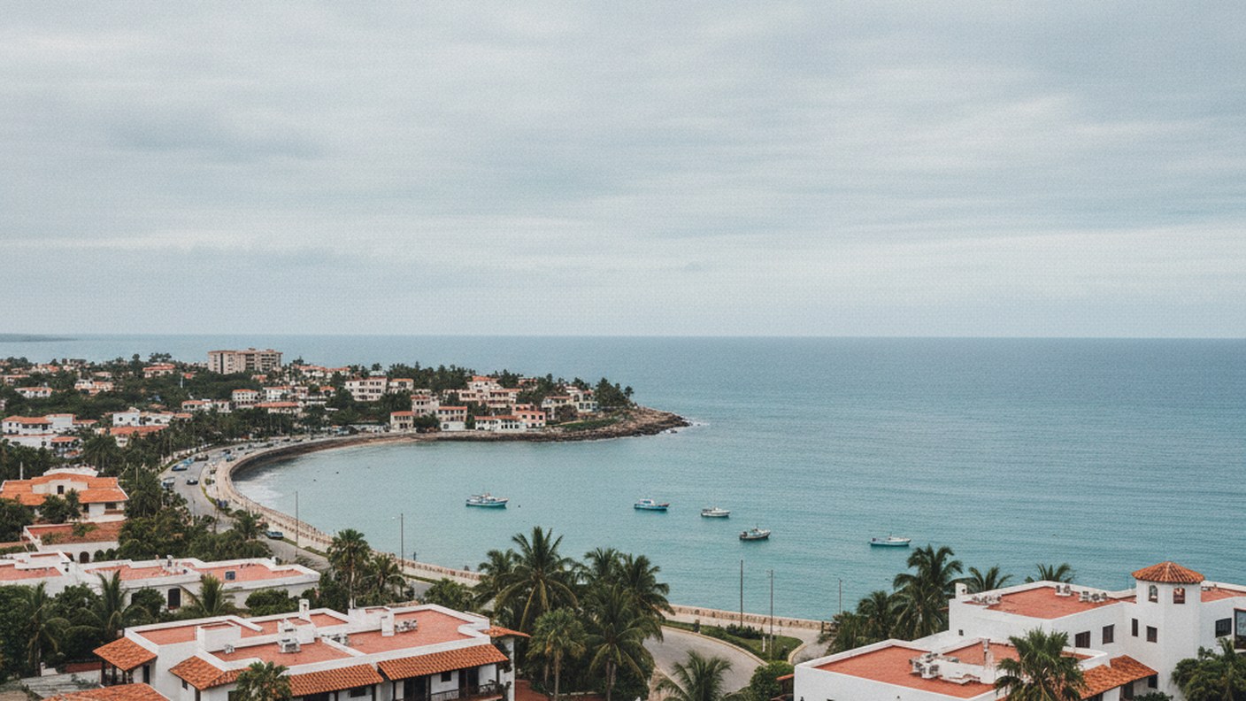 coastal neighborhood with water and low buildings under a cloudy sky